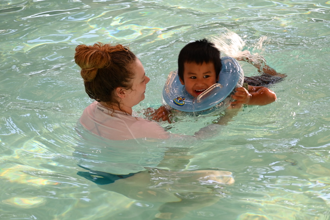 Child learning to swim with one-on-one instruction